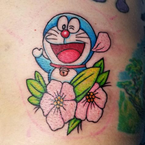 I got to do the Doraemon Fuji's favorite character tattoo on Chappy today.  Love the colors we used in it.  The center of the flowers are acutally bright yellow but they were the last thing we tattooed so they are a bit dark from the blood showing through the color.  Over all though I like the way it turned out. Doraemon Tattoo Design, Doraemon Tattoo, Cartoon Noses, Arm Cover Up Tattoos, Tato 3d, Khmer Tattoo, Small Chest Tattoos, Doraemon Wallpapers, 3d Tattoos