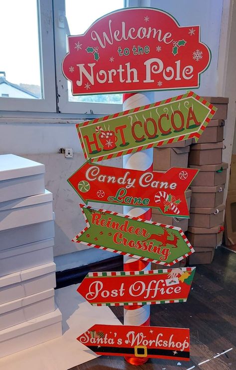 Christmas Grotto Decorations, Christmas Directional Signs Diy, North Pole Party Ideas, Christmas Poles Diy, Santas Work Shop Decoration, Christmas Decor Signs Diy, Diy North Pole Decoration, Diy Santa Grotto, Office Christmas Door Decorations Ideas