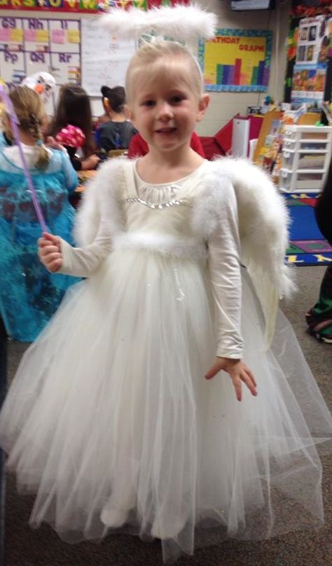 DIY Angel/Fairy Halloween costume I made for my 4 year old. She was in a wedding a few months before and I decided to use her flower girl dress for costume which worked perfect (thanks @alcibiadesh8)!!!!! I bedazzled it with some stones and fury trim. I was going to make the wings but found a cute wing set that included the halo at a local craft store. I ended up sewing the wings to the dress straps so they wouldn't continually fall off as she ran from house-to-house to get candy! Diy Angel Costume For Kids, Toddler Angel Costume, Kids Angel Costume, Girls Angel Costume, Angel Costume Diy, Fairy Fancy Dress, Fairy Halloween Costume, Angel Halloween Costumes, Halloween Costume Toddler Girl