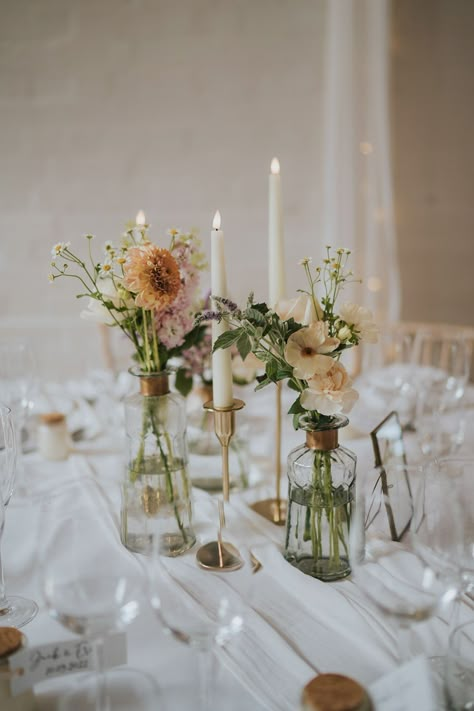 Simple Color Schemes Wedding, Wildflower Wedding Circle Table, Circle Tables With Bud Vases, Round Wedding Table Inspiration, April Wedding Flowers Centerpieces, Candlestick And Bud Vase Centerpiece, Bud Vases Wedding Centerpiece Round Table Setting, Bud Vase Table Decor, Cozy Wedding Decor