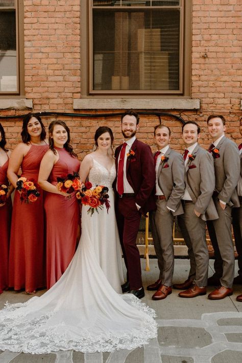 The most important thing about your wedding attire is that you're comfortable... Confidence and comfort show in your photos! You won't be tugging at your attire all day, and you'll exude confidence because you know you look good. Red And Orange Wedding Groomsmen, Maroon Suit Wedding Party, Burgundy Bridal Party Groomsmen, Maroon And Brown Wedding, Fall Color Wedding Party, Burgundy Groomsmen Attire Fall Wedding, Burgundy And Tan Wedding Party, Gray And Burnt Orange Wedding, Orange Maroon Wedding