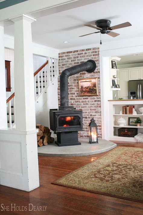 16 Best DIY Corner Fireplace Ideas for a Cozy Living Room in 2019 Built In Shelves Living Room Wood Stove, Wood Stove White Brick, Concrete Hearth Pad, Wood Stove Backing, Brick Wall Behind Wood Stove, Wood Stove Built In, Basement Pellet Stove Ideas, Wood Stove In Corner, Stand Alone Fireplace Living Rooms