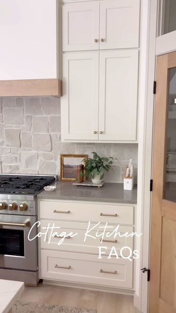 Tracy Baggett on Instagram: "Cottage kitchen @peninsulapinescottage FAQs and Answers!   1) What is your cabinet color? Cabinets are @sherwinwilliams White Duck. It’s the perfect creamy hint of beige white.  2) Where did you find the backsplash? Stone backsplash is @flooranddecor Alamo Sandstone Random Ledger Panel - I’ll share install details in another reel! 3) Stool link? Stools are an Amazon find! Write SHOP below for the exact link. 4) Countertop Info? The island is Lumataj stone quartz (a great option to save $ if you like the look of Taj Mahal quartzite! Perimeter is Daintree Gray quartz. 5) Brass Shelf Rail info? I ordered from Etsy! Linked by commenting SHOP. 6) Flooring details? LVP from @duradecor - San Tropez 7) Lighting link? From @hunterfanco  8) Hardware source? Also from Ama White Cabinets Natural Stone Backsplash, White Kitchen Stone Backsplash, Creamy Cabinets Kitchen, Stone Impressions Tile Backsplash, Limestone Tile Backsplash Kitchen, Kitchen Limestone Backsplash, Cream Cabinets Stone Backsplash, Kitchen Stone Backsplash, Brass Shelf Rail