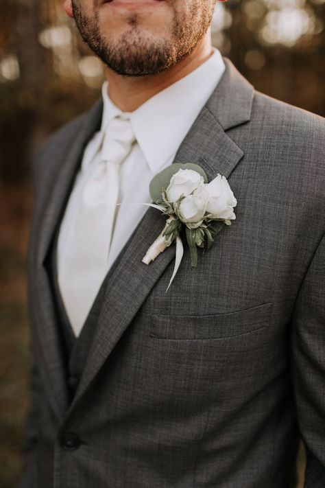 Such a classic wedding look for this groom! Gray suit with a crisp white shirt and tie & white roses for his bout. Florals by @sainteterre Photo by Christi Martin Photography Men Grey Tuxedo Wedding, Wedding Suit Light Grey, Grey Suit Boutonniere, Wedding Groom Suit Grey, Heather Grey Suit Wedding, Groom In Grey Suit, Rose Buttonholes Wedding, Gray Wedding Suit For Groom, Light Gray Suit Wedding