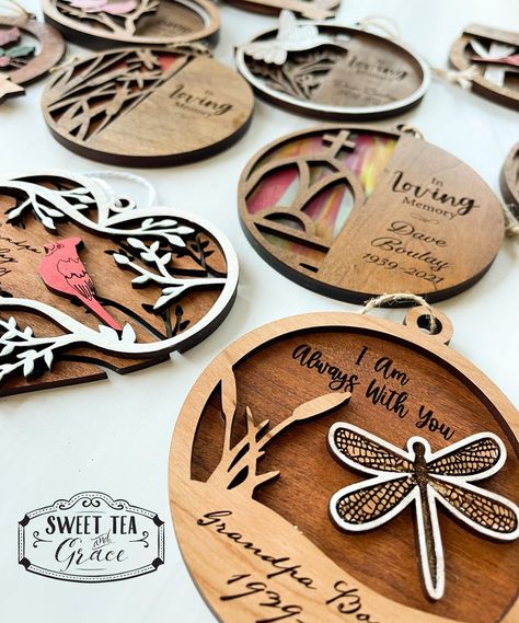 "Beautiful layered laser cut and engraved memorial wood ornament customized with name and date. This is such a sweet sentiment to give to anyone who experienced a loss. It is something that will be cherished for many years. * 11 designs to choose from * 3 wood stains + natural wood to choose from * Choose your font for the name/dates * Beautiful multi layered ornaments When ordering please include: 1. Personalization - Name and or Dates (type exactly as it should be printed) 2. Wood stain or paint color for the TOP piece (see charts) 3. Wood stain or paint color for the BOTTOM piece  (see charts) 4. Font selection for name/dates (1-12) 5. OPTIONAL: Extra requests Measures approximately 4\" and is either 2 or 3 layers depending on the ornament design. Some ornaments are partially painted. T Beginner Laser Engraving, Laser Christmas Gifts, Layered Wood Projects, Laser Crafts To Sell, Diy Laser Engraver Projects, Laser Wood Ideas, Wood Laser Engraving Ideas, Laser Engraver Projects, Laser Engraving Ideas Projects