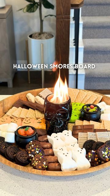 Kristin Miller | Creator | Dallas, TX on Instagram: "Halloween smores board💀Comment “fun” to get everything sent directly to your DMs! This skull fire pit is a must have this spooky season! This would be great to bring to a halloween party or have for a date night at home. Save & share with someone you want to make this with🎃 • WHAT YOU NEED: • large board or tray • mini tabletop firepit • marshmallows • assorted chocolates and candies • graham crackers and cookies • skewers • • #halloweenideas #halloweensmores #smores #halloweendesserts #easydessert #partyideas #halloweenparty #foodboard #halloweenrecipes" Halloween Nacho Table, Halloween Cookie Tray, Halloween S’mores Board, Halloween Board Night, Halloween S’mores Charcuterie, Fall Teen Party Ideas, Halloween Fondue Ideas, Fall Date Night At Home, Spooky Picnic Ideas