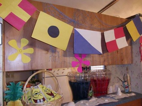 Krusty Krab flags, netting and beach sand with shells sets the scene for a SpongeBob birthday party Krusty Krab Party, Krusty Krab Decorations, Krusty Krab Birthday Party, Spongebob Birthday Decor, Spongebob Pool Party, Spongebob Birthday Party Decorations Diy, Spongebob Birthday Decorations, Spongebob Birthday Ideas, Spongebob Themed Birthday Party Ideas