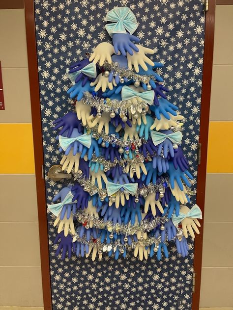 My husband is a school nurse. For his clinic door, he made a tree from surgical gloves and masks and plans to add band-aid boxes for gifts. :) Christmas Door Decorations Medical, Nursing Home Door Decorations Christmas, Christmas Door Decorating Contest Medical Office, Medical Door Decorating Contest, School Nurse Door Decoration Christmas, Medical Christmas Door Decorations, Clinic Christmas Decorations, School Nurse Christmas Door, Hospital Christmas Decorations