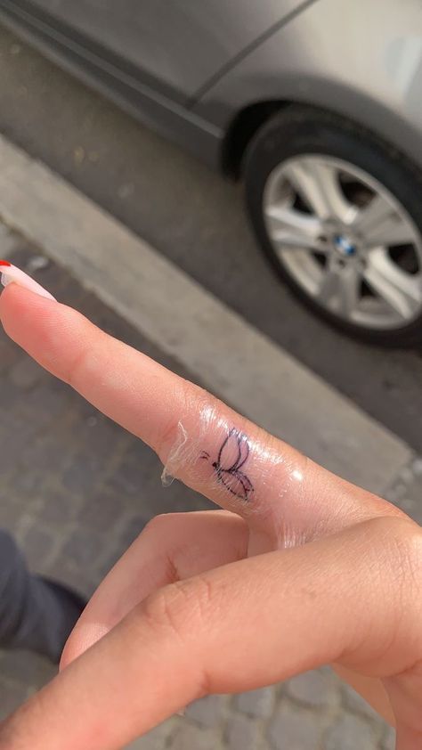 Small Butterfly Tattoo On Finger, Finger Tattoos On The Side, Finger Tattoo Butterfly, Minimalist Tattoo Finger, Tiny Butterfly Tattoo Simple, Butterfly Tattoo Finger, Mini Finger Tattoos, Butterfly Finger Tattoo, Jewellery Nails