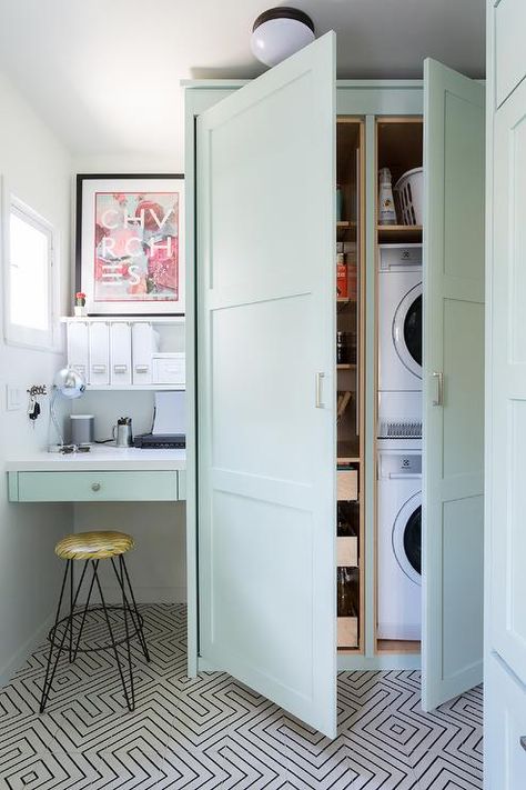 A stacked white front loading washer and dryer is hidden in floor-to-ceiling mint-green cabinets. Hidden Door In Laundry Room, Laundry In Kitchen Ideas Hidden, Hidden Washer And Dryer In Kitchen, Outdoor Washer And Dryer Ideas, Laundry Cabinet Ideas, Hidden Laundry Rooms, Laundry Cabinet, Hidden Laundry, White Laundry Rooms