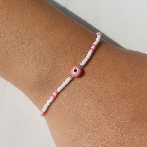 Pink Evil Eye Bracelet | Dainty Evil Eye, Evil Eye Beads, Seed Bead Bracelets, Evil Eye Beaded Bracelets, Beaded Anklet, Stretch Bracelets Evil Eye Bracelet Ideas, Bracelets Evil Eye, Pink Evil Eye, Braided Bracelet Diy, Handmade Evil Eye, Evil Eye Beads, Pride Bracelet, Bracelets Beaded, Good Luck Bracelet