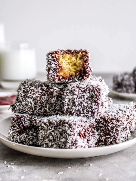 An Australian classic! Lamingtons are deliciously buttery cakes that are coated in a silky chocolate glaze and rolled in crispy, dried coconut. They're the ultimate snack cake to take on the go! Lemington Cake Recipes, Lemington Cake, Lamingtons Cake, Lamington Cake Recipe, Lamington Recipe, Lamington Cake, Lamingtons Recipe, Cakes Vanilla, Australian Recipes