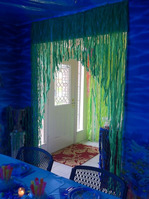 the doorway is covered with seaweed made of green crepe paper that's crumpled. Crepe Paper Seaweed, Underwater Set Design, Under The Sea Hallway Decorations, Crepe Paper Ideas, Birthday Decorations Green, Hoco Decor, Underwater Decor, Homecoming Hallways, Ocean Display