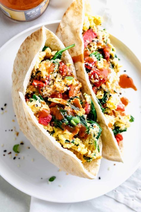 These 8-minute Breakfast Pitas are a filling, satisfying, and delicious way to start the day! Made with scrambled eggs, sweet roasted peppers, and spinach, and topped with melted cheese, they are a great way to pack protein and veggies into your busy morning routine! Get the best Breakfast Pita recipe at www.healthyseasonalrecipes.com! Breakfast Pitas, Breakfast Pita Recipes, Pocket Recipes, Mediterranean Diet Breakfast Recipes, Video Cloud, Artichoke Frittata, December Recipes, Breakfast Pita, Pita Recipe