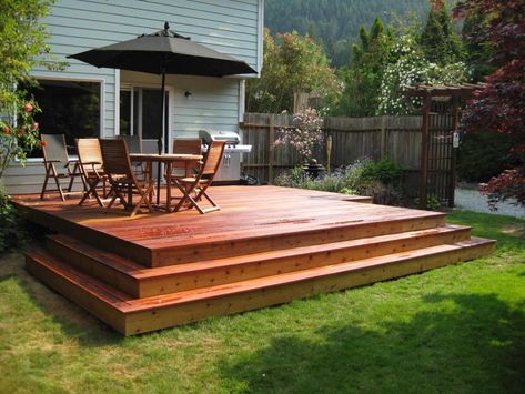 7 Best Deck Colors for Grey House That You Must Choose – JimenezPhoto Best Deck Colors, Grey Siding House, Dark Deck, Orange Building, Dark Grey Houses, Deck Stain Colors, Contemporary Deck, Grey Siding, Cedar Deck