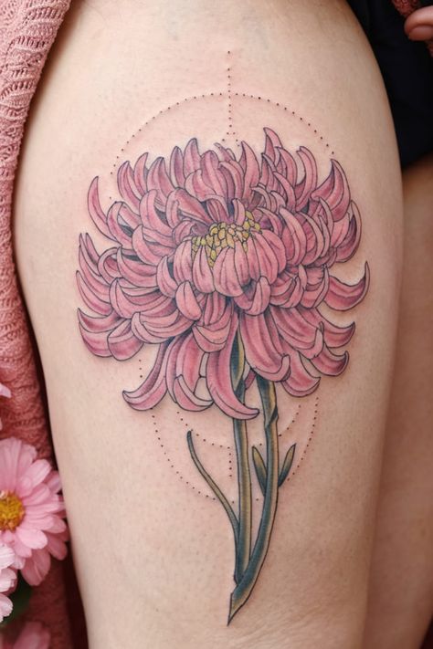 A pink chrysanthemum tattoo on the thigh symbolizes longevity, happiness, and love. This floral design is full of intricate petals that create a stunning, detailed look, and the pink hue softens the boldness of the flower.