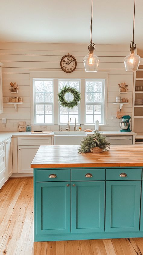 Bright farmhouse kitchen with turquoise island, wood countertop, teal cabinets, and natural light creating a cozy atmosphere. Airy Farmhouse, Blue Cabinetry, Glamorous Kitchen, Functional Kitchen Island, Wall Clock Classic, Above The Sink, Lake House Kitchen, Kitchen Island Ideas, Wood Countertop