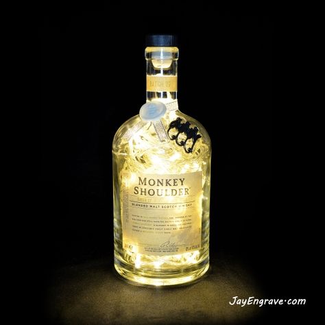 This LED bottle lamp has been made by upcycling a Monkey Shoulder Malt Scotch Whisky bottle. This is a rare 1L Monkey Shoulder whisky bottle fitted with 80 warm white LEDs. Monkey shoulder whisky bottles are highly collectable and sought after due to their cool shape and distinguishing metal monkey logo embossed around the bottle shoulder. A rubber seal is fitted inside the drilled hole to help protect the leds cable. Monkey Shoulder, Bottle Lamps, Monkey Logo, Whisky Bottle, Cool Shapes, A Monkey, Bottle Lamp, Scotch Whisky, Decanters