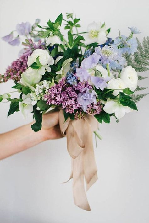 Bouquet with sweet peas, hellebores, hyacinths, ranunculuses, fritillarias, muscari, scabiosas, lilacs, and delphinium in soft shades of blue and purple Sweet Pea Wedding Flowers, Sweet Pea Bouquet, Bridal Bouquet Spring, Wedding Flower Guide, Lilac Bouquet, Spring Wedding Bouquets, Purple Wedding Bouquets, Blue Wedding Bouquet, Purple Wedding Flowers