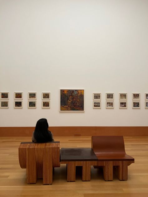 A girl sitting down at an art gallery, staring at wall art that depicts nature and the different seasons Art Gallery Bench, Art Gallery Seating, Art Gallery Furniture, Gallery Bench, Museum Bench, Gallery Furniture, Cultural Centre, Wooden Bench, Coworking Space