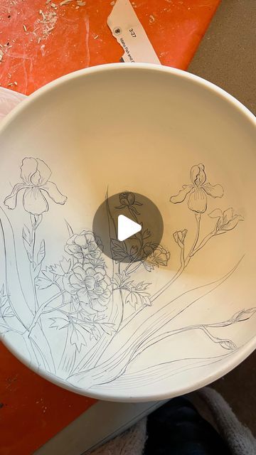 Autumn Higgins on Instagram: "Welcome back to last minute pottery! 
Iris and Peony bowl update: 
This serving bowl made it into the bisque kiln! 
I’ve been using this inlay technique for years and years, but it’s always exciting to watch the magic when I wipe off the black stain and reveal the nice crisp lines.  I just started working with an Iris motif, but have never drawn peonies before. I’m so excited to see how this turns out. And also see what inspiration this spring and summer’s flowers bring me!

In this video: 
I have bone dry bowl that a carved the design into when it was leather hard. 

I paint on black mason stain (I’m using a fan brush but I also often use a soft Chinese brush from the clay store 

Next I use a wet sponge to wipe off the stain. (This is where it is important t Drawn Peonies, Bisque Pottery, Chinese Brush, Fan Brush, Black Stains, Kiln, Last Minute, Welcome Back, Peonies