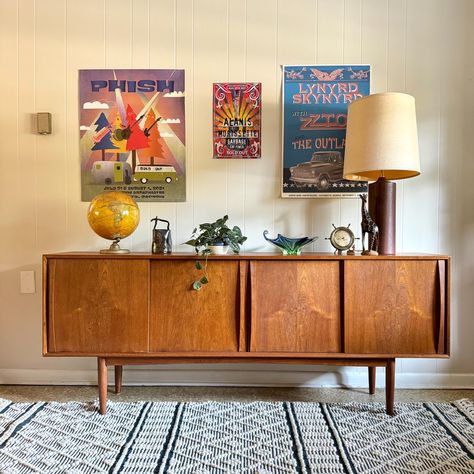 Mid-Century Teak Sideboard by S.T.M. Møbler This stunning mid-century modern teak sideboard is a timeless piece designed by S.T.M. Møbler. Crafted from high-quality teak, it features clean lines and a minimalist aesthetic characteristic of Scandinavian design. The rich, warm tones of the wood add a touch of elegance, making it a perfect fit for any living or dining space. The sideboard offers ample storage with four sleek doors that seamlessly blend into the design, providing space for your esse Mid Century Sideboard Dining Room, Teak Sideboard Living Room, Teak Console Table, Wood Tone Living Room, Midcentury Modern Living Room Design, Mid Century Apartment Decor, Styling A Sideboard, Mid Century Scandinavian Living Rooms, Mid Century Decorating Ideas