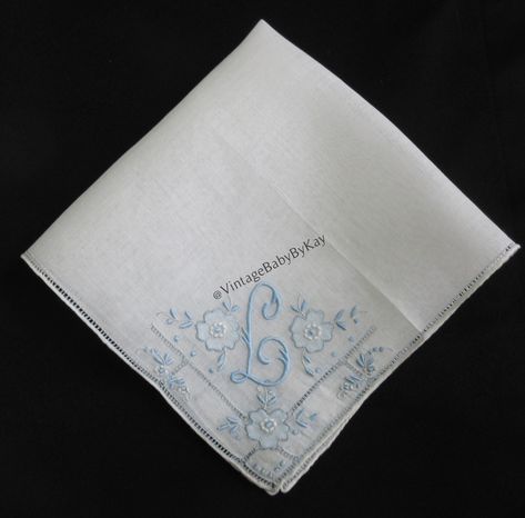 This sweet white handkerchief has a beautiful script L monogram, framed with an elaborate embellishment of dots and flowers, all in blue and white. Techniques used include surface embroidery, Madeira style applique and hemstitching. There is a smaller Madeira motif in each additional corner.  The hanky is made from sheer, cotton-linen blend fabric. It is unused and still has its original tag which reads "Linen 52%, Cotton 48%, Made in Hong Kong, Exclusive of Decoration." Size is 12" square. This heirloom quality hanky would make a lovely "something blue" for a bride! It is in excellent condition. I did not launder it on account of the tag, but I do not detect any stains, odors or tears. For vintage linens I recommend hand washing and line drying. I have a twin of this hanky with pink embel Wedding Hankies, Blue Embroidery, Something Old, Something Blue, Vintage Linens, White Wedding, Cotton Linen, White Vintage, Linen Blend