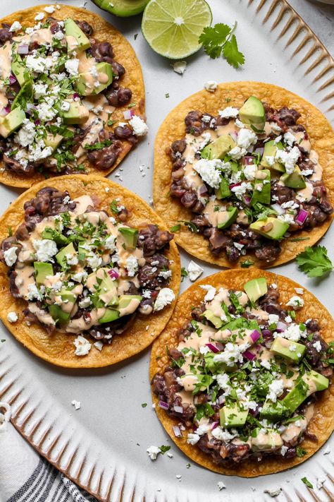 Black Bean Tostadas - Dishing Out Health Vegetarian Tostadas, Bean Tostada, Dynamite Sauce, Black Bean Tostadas, Traditional Refried Beans, Bean Tostadas, Vegetarian Tacos Recipes, Easy Vegetarian Dinners, Dishing Out Health