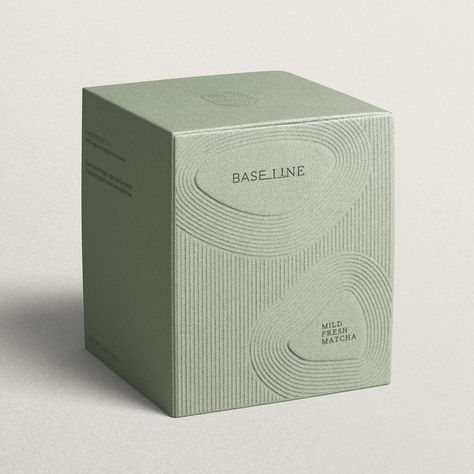 A cardboard soft green tea box with an embossed line pattern inspired by Kyoto gardens. It features the company, Baseline, logo and product description inside a pebble shape. Matcha Packaging, Mises En Page Design Graphique, Visuell Identitet, Luxury Packaging Design, Skincare Branding, Cosmetic Packaging Design, Skincare Packaging, Perfume Packaging, Candle Packaging