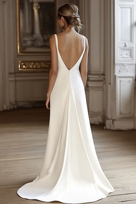 A woman in a white, backless wedding gown with a long, flowing train stands in an elegantly decorated room with wooden floors and ornate wall moldings. Her hair is styled in an updo. Minimalist Wedding Gown Simple, Long Plain Wedding Dress, Voile Wedding Dress, Plain Bride Dress, Simple Wedding Dress Silk Satin, Simple Wedding Dress Long Train, Elegant Wedding Dress Low Back, Bride Dress Simple Elegant, Caroline Castigliano Wedding Dress