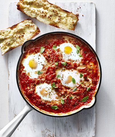 Italian Baked Eggs | RealSimple.com Italian Baked Eggs, Eggs In Purgatory, Shakshuka Recipes, Baked Eggs Recipe, Homemade Marinara, Christmas Brunch, Egg Dish, Baked Eggs, Iron Skillet