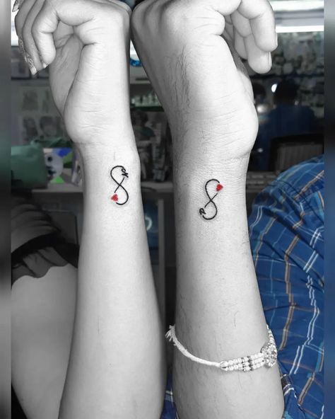 Matching infinity tattoo designs for couples who want to claim their love for each other. Cute, minimalistic couple tattoo ideas. Cute Boyfriend Tattoo Ideas, Couples Mini Tattoos, Gaming Couple Tattoos, Stronger Together Tattoo, Infinity Matching Tattoos, Wifes Name Tattoo Ideas For Men, Marriage Tattoos Husband Wife, Tiny Couples Tattoos, Tattoo Ideas Matching Couple