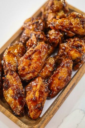 Sticky Honey Garlic Wings are irresistibly delicious and perfect for satisfying your wing cravings! These chicken wings can be fried, oven baked or air fried until golden and crispy, then tossed in a sweet-sticky honey garlic sauce. Serve as an easy to make dinner or appetizer for a deliciously satisfying treat. Honey Garlic Wings, Oven Chicken Wings, Chicken Wing Recipes Fried, Honey Chicken Wings, Air Fry Chicken Wings, Honey Garlic Chicken Wings, Garlic Wings, Garlic Chicken Wings, Honey Garlic Sauce