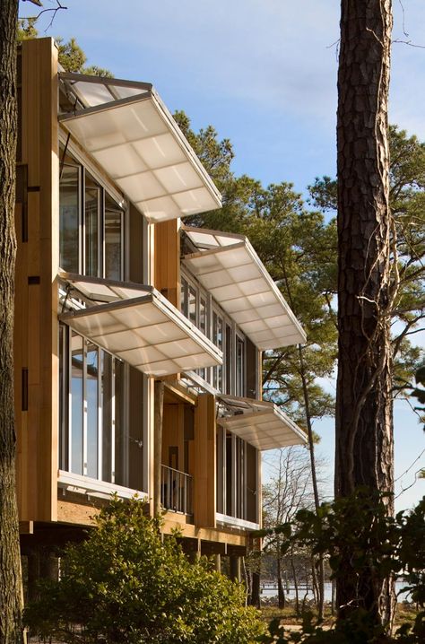 Hangar doors on the west facade can be tuned to the angle of the sun as it changes over the course of the day. Here, they are in the awni... Butterfly Pavilion, Passive House, Design Exterior, Pergola Shade, Facade Architecture, Facade Design, Design Case, Container House, Shutters