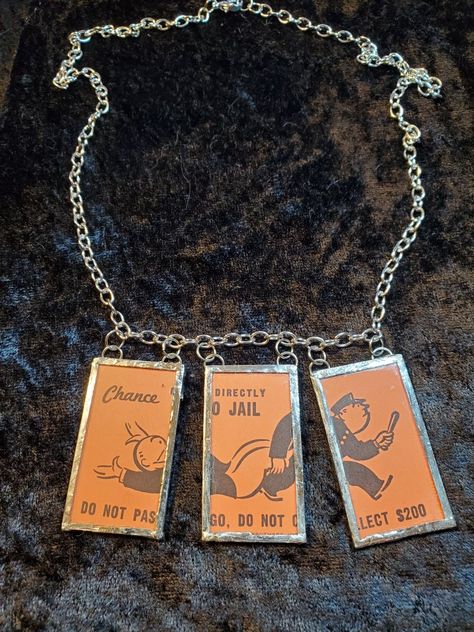 Monopoly card glass necklace. Another one of a kind I Handcrafted Board Game Jewelry, Monopoly Jewelry, Monopoly Necklace, Monopoly Charm Bracelet, Necklaces On Playing Cards, Diy Jewelry Recycled, Vintage Monopoly, Game Jewelry, Monopoly Money