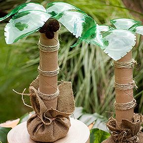 Luau Decor: Palm Tree Centerpieces Top the buffet table with palm trees made from recycled green soda bottles, paper towel tubes, and twine. Palm Tree Centerpieces, Luau Ideas, Trees Diy, Vbs Decorations, Luau Decorations, Prom Event, Luau Birthday Party, Moana Birthday Party, Fiesta Tropical