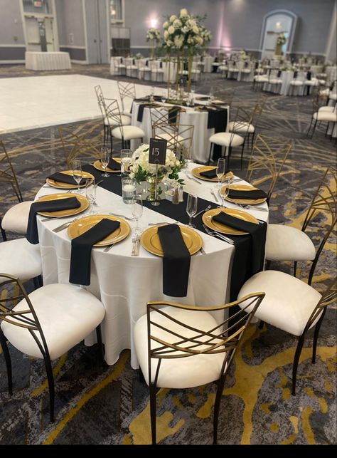 Silver And Gold Centerpieces Party Ideas, Simple Black And Gold Table Decor, Black White And Gold Table Decor, Black And Gold Dinner Table, Black And Gold Long Table Decor, Round Table With Black Tablecloth With Gold Runner, Black And Gold Banquet, Black Table Cloth With Gold Runner, Black And Gold Table Decorations