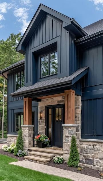 Modern Farmhouse Exterior Picturesque Blend of Blue Siding Stonework and Wood Accents | Premium AI-generated image Dark Blue House With Wood Accents, Dark Blue Hardie Board Siding, Exterior House Material Options, Paint Schemes Exterior House, Navy Blue Home Exterior, Dark Blue Houses Exterior, Gray Blue House Exterior, Gray Siding Black Trim, Blue Vertical Siding