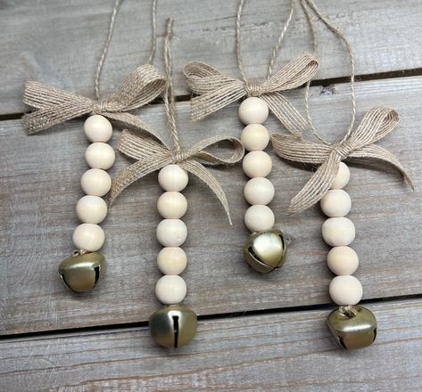 ❤️Welcome to Farmhouse Finesse ❤️ These beautiful farmhouse/boho chic ornaments are the perfect addition to decorate your farmhouse Christmas tree with! They are also beautiful when used as accents on holiday gift toppers as well as for your everyday decor on decorative trays and etc! They are made of natural wooden beads with a gold bell at the bottom and a cute burlap bow at the top! These come in a set of 12.  *burlap bow may vary slightly due to availability* Thanks for shopping with us❤️ Wooden Beads Christmas Tree, Christmas Ornaments With Wooden Beads, Wooden Beads Christmas Decor, Wooden Bead Christmas Crafts, Farmhouse Style Christmas Decor, Wooden Bead Projects, Wooden Bead Crafts Diy, Wooden Bead Ornaments Diy, Wood Bead Ornaments Diy