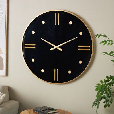 Ideal for living rooms or bedrooms, this black wall clock for home adds a touch of sophistication. Requires 1 AA battery, not included. This item ships in 1 carton. Clock has a black clock face with gold hands and gold lines and round buds for minute markers. The clock mechanism runs silent. Can be hung vertically using the keyholes; nails and screws not included. Suitable for indoor use only. This item ships fully assembled in one piece. This is a single black colored kitchen clock. Modern styl Coloured Kitchen, Colored Kitchen, Wall Clock Black, Black Clock, Decorative Wall Clock, Kitchen Clock, Black Clocks, Black Wall Clock, Kitchen Clocks