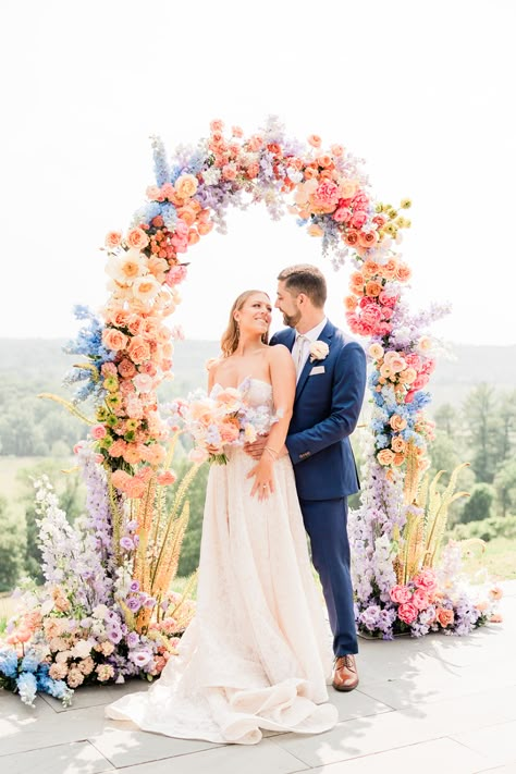 Bride and groom at pastel rainbow wedding arch #rainbowwedding #pastelwedding #floralwedding #rainbowflorals Wedding Ideas Summer Colors, Pastel Wedding Theme, Bridgerton Wedding, Colorful Summer Wedding, Wildflower Wedding Theme, Lover Album, Rainbow Wedding, Bright Wedding, Summer Wedding Colors