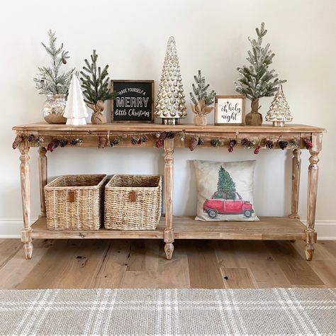 Entryway table decorated for the holidays. Christmas trees in different textures and heights. World Market Everett Foyer table. #christmasdecor #christmasinspiration #christmastreedecorideas #entrywaytable #entrywaydecor #entrywayideas #christmashomedecorideas Entryway Christmas Table Decor, Everett Foyer Table Christmas, Little Christmas Trees On Table, Christmas Entryway Decor Table, Foyer Table Christmas Decor, Christmas Console Decor, Christmas Foyer Table Decor, Foyer Christmas Decor Entryway, Entryway Table Christmas