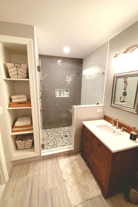 Our amazing remodeling team transformed our customer's bathroom into a calm oasis -- complete with a luxurious shower with new tiles and and built in cubbies to store linens and towels. Bathroom Built Ins, Built In Cubbies, Tub To Shower Remodel, Accessible Bathroom Design, Bathroom Transformation, Bathroom Redesign, Master Bath Remodel, Bathroom Remodel Designs, Bathroom Layout