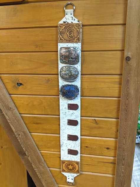 Buckle Wall Display, Belt Buckle Storage Ideas, Leather Belt Buckle Display, Livestock Ribbon Display, Cowhide Display Ideas, Belt Buckle Wall Display, Rodeo Buckle Display, Western Belt Buckle Display, Trophy Buckle Display