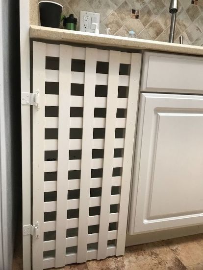 A customer of mine had a trash compactor that no longer worked.  I suggested removing It and using the space for trash cans.  I designed a lattice door with inexpensive material from Menards.  Initially I installed it with hinges.  We then decided to install a double trash can unit that slides out like a drawer.  I removed the hinges and fastened the door to the unit.  The result is much more attractive than the old compactor.  I have made two of the lattice doors.  Now my wife wants o… Double Trash Can, Trash Can Ideas, Hide Kitchen, Lattice Door, Diy Drum Shade, Hidden Tv Cabinet, Plastic Lattice, Can Ideas, Cabinet Doors Repurposed