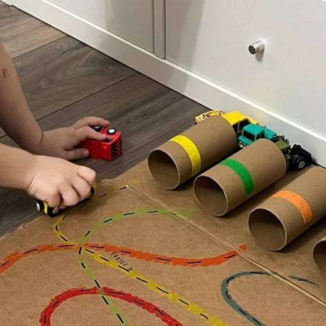 Desiree Blanchard, M.H.K | Baby & Toddler Play on Instagram: "🛑👀STOP THE SCROLL IF YOU LOVE A SIMPLE DIY ACTIVITY! Click the ✨FOLLOW✨ button to continue learning more! To recreate this activity, use TP rolls to make the “garages,” add coloured tape (or marker) on each roll and then tape them flat to a piece of cardboard. We like to use two-way tape for this. Add corresponding “roads” using markers and find small matching coloured cars. That’s it! Have fun! 🫶🏻 ➡️For more, check out my Baby and Toddler Caregiver Play & Milestone guides. It’s loaded with tips, milestones & play ideas! 🔗 in bio • • • #momssupportingmoms #newmomsupport #momoflittles #babysfirstyear #grossmotordevelopment #babydevelopment #babymilestones #mommyandmetime #tummytimefun #newmomsupport #momoflittles #grossmotor Things With Wheels Activities, Car Sensory Activities, Cars Eyfs Activities, Road Safety Activities For Toddlers, Vehicle Activities For Toddlers, Diy Stop Light, Cars Activities For Toddlers, Car Activities Preschool, Car Preschool Activities