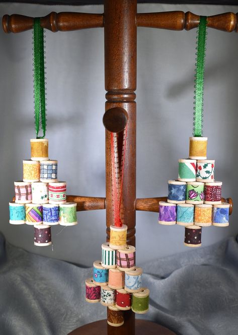 "Spool Tree Christmas Ornament to adorn you tree or tie on a package for an added treat.  Spools are covered in various fabrics with a brown fabric trunk and gold fabric spool for the star on top.  A great little addition to your tree.  Price is per ornament.  Spools are covered in a variety of fabrics as shown in pictures.  We will choose for you as there really isn't a way to individually mark them.  Tree is approximately 2.5\" tall and 3.75\" wide.  Hanger is approximately 3.5\" long. Orders are processed in 2 - 3 business days although we do our best to ship as quickly as possible.  All items listed are completed items." Wooden Spool Crafts, Christmas Orniments, Winter Diy Crafts, Spool Crafts, Diy Christmas Ornaments Easy, Wood Spool, Quilted Christmas Ornaments, Wooden Spools, Christmas Gift Decorations