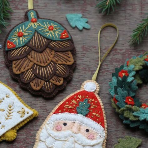 Kiriki Press on Instagram: "Orders are now open for the Advent Calendars! I’ve carefully crafted 12 festive and fun wool-blend felt kits that will keep you stitching all December long. So far, I’ve shared half of the designs with you. Each one is part of a set that remains a surprise until you unbox it on its special day. Every component is pre-cut and the embroidery patterns are printed directly onto the felt. This means you can produce these charming ornaments with around 45-60 minutes of crafting time per day. I absolutely love the entire collection... Some of my favourites are the “secret” ornaments. If you like what you see with these 6, I’m sure you will love to have all 12!" Green Felt Ornaments, Hand Embroidered Felt Ornaments, Felt Picture Frame Ornament, Felt Sewing Projects Free Pattern, 12 Days Of Christmas Felt Ornaments, Cute Felt Ornaments, Felt Stocking Ornaments, Felt Sweater Ornament, Felt Diy Christmas Ornaments