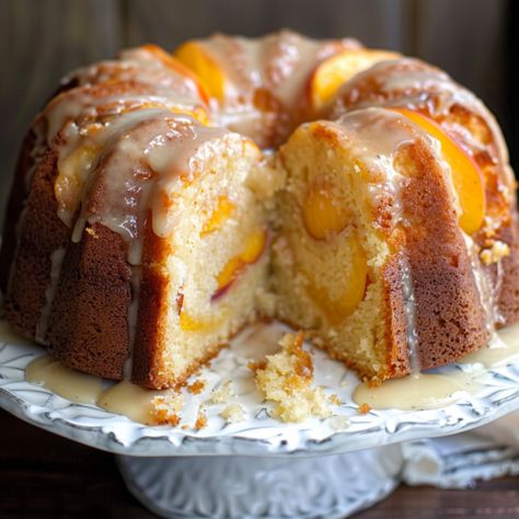 Easy Sour Cream Peach Pound Cake is a celebration of the season's finest flavors, combining the richness of traditional pound cake with the lusciousness of fresh peaches. Whether enjoyed as a dessert or a sweet indulgence with your morning coffee, this cake is sure to Apricot Nectar Pound Cake, Fresh Peach Bundt Cake, Sour Cream Peach Cake, Peach Bundt Cake Easy, Cakes With Fruit In Them, Summer Bunt Cakes, Sour Cream Peach Pound Cake, Peach Pound Cake Recipe Sour Cream, Fresh Peach Bundt Cake Recipes