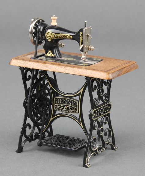 Lot 278, A miniature metal and wooden model of a treadle sewing machine 3" x 3 1/2" x 1 1/2" est £30-50 Tailor Machine, Jhula Decoration, White Sewing Machine Vintage, Miniature Sewing Machine, New Home Sewing Machine Vintage, Antique Singer Sewing Machine, Old Sewing Machine, Singer Genie Sewing Machine For Sale, Peacock Pictures